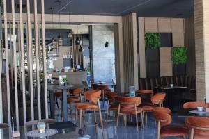a restaurant with wooden chairs and tables and a bar at Prenoćište BIS in Prijepolje