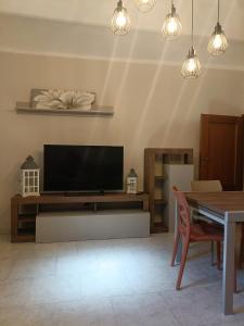 a living room with a flat screen tv on a wall at La terrazza sul fiume in Spoleto