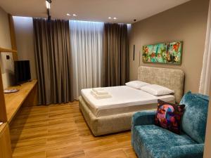 a hotel room with a bed and a couch at SD House in Vlorë