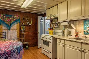 a kitchen with a sink and a stove top oven at Come Friday Cottages in Bacliff