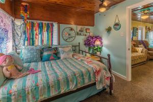 a bedroom with a bed with a teddy bear on it at Come Friday Cottages in Bacliff +52 photos