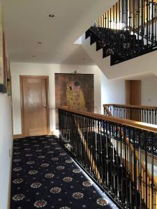 a staircase in a building with a rug on the floor at Red Gate House B&B in Malin