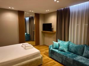 a hotel room with a bed and a couch at SD House in Vlorë