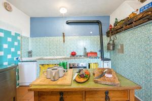 a kitchen with a wooden table with a plate of food on it at Villa I Tre Archi for 6 with Private Garden - Happy Rentals in Pisano