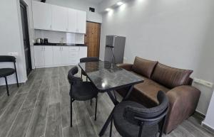 a living room with a table and a couch at Welcome3 in Achʼqva