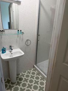 a bathroom with a sink and a shower at Ashfield in Breakish +18 photos