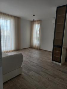 a living room with a couch and a mirror at Рока Резиденс in Ravda