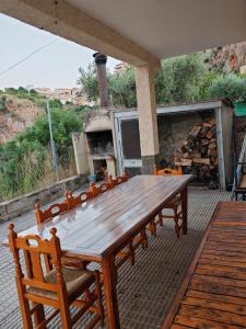a large wooden table and chairs on a patio at Casa Chorreón in Letur