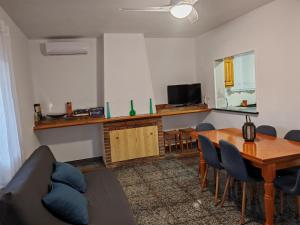 a living room with a couch and a dining room table at Casa Chorreón in Letur