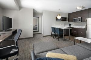 a living room with a couch and a kitchen at Residence Inn by Marriott Warner Robins in Warner Robins