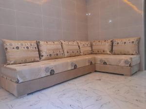 a long couch sitting in a room at Relax House 2 in Al Massira Airport