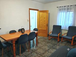 a conference room with a wooden table and chairs at Casa Chorreón in Letur