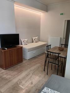 a living room with a bed and a table at GAIA City Studio in Kato Achaia