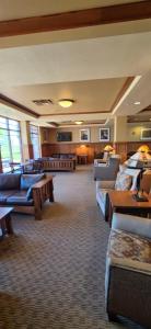 a large room with couches and tables in a building at Canal Park Lodge in Duluth