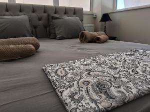 a bed with a black and white blanket on it at GAIA City Studio in Kato Achaia