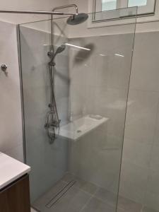 a shower with a glass door in a bathroom at GAIA City Studio in Kato Achaia +15 photos