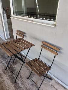two wooden chairs sitting next to a window at GAIA City Studio in Kato Achaia