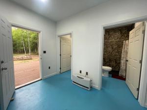 an empty room with a toilet and a door at Ma-Su Thunder Cabin #1 in Houston