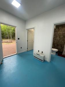 an empty room with a door and a toilet in it at Ma-Su Thunder Cabin #1 in Houston +18 photos