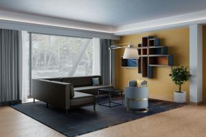 a living room with a couch and a chair at Four Points Flex by Sheraton Parma in Parma