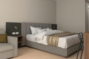 a bedroom with a large bed and a chair at Four Points Flex by Sheraton Parma in Parma +64 photos