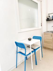 a white table and two chairs in a kitchen at Marechiaro apartment in Monopoli
