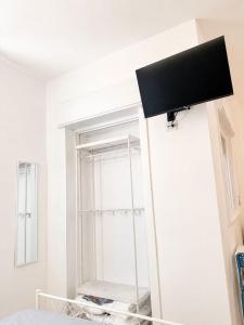 a room with a mirror and a tv on the wall at Marechiaro apartment in Monopoli