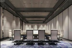 a conference room with a long table and chairs at Four Points by Sheraton Linyi Hedong in Linyi