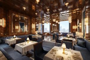a restaurant with tables and chairs and a large window at Jakarta Marriott Hotel Gelora in Jakarta