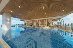 a hotel pool with a view of the city at Jakarta Marriott Hotel Gelora in Jakarta