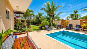 a house with a swimming pool and a patio at Pousada Recanto do Chef in Búzios