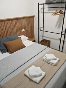 a bed with two towels sitting on top of it at Casa Chorreón in Letur +21 photos