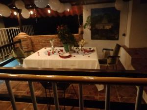 a table with a white table cloth and flowers on it at Casa Tepehucan in Malinalco +9 photos