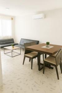 a living room with a table and chairs and a couch at Villa Bonita Torre 11 3 in Cozumel