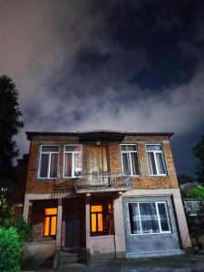 an old brick house with its lights on at Cozy home in Zugdidi