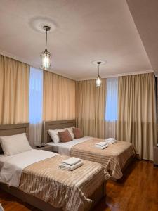 two beds in a hotel room with windows at Horizont Boutique Hotel in Telavi +46 photos