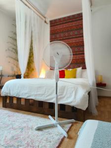 a bedroom with a bed with a fan on the floor at Solaris in Ostrava