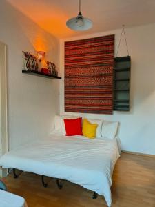 a bed with four colorful pillows in a room at Solaris in Ostrava