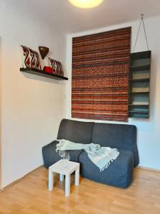 a living room with a blue couch and a table at Solaris in Ostrava +63 photos