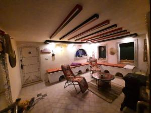 a living room with a couch and a table and chairs at La maison des oliviers in Houmt Souk
