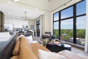 a living room with a couch and a large window at The Eighth Luxury Penthouse in Fourth Ward in Charlotte