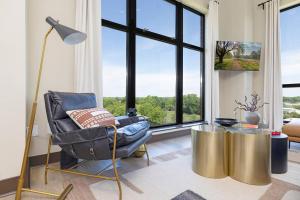 a living room with a chair and a table at The Eighth Luxury Penthouse in Fourth Ward in Charlotte