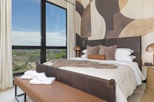 a bedroom with a large bed with a large window at The Eighth Luxury Penthouse in Fourth Ward in Charlotte +48 photos