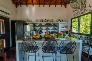 a kitchen with a counter with fruit on it at Villa Noelia by Embera Collection in Saboga