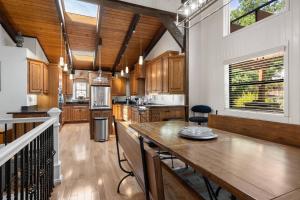 a kitchen with wooden cabinets and a large wooden table at Sues Lake House in Buford