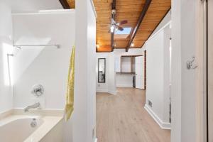 a bathroom with a tub and a ceiling fan at Sues Lake House in Buford +35 photos
