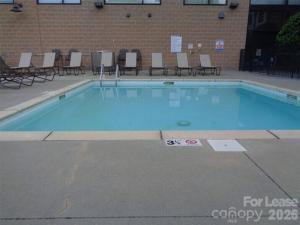 a large swimming pool with chairs in a building at The Eighth Luxury Penthouse in Fourth Ward in Charlotte