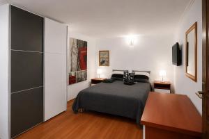 a bedroom with a bed and a desk with two lamps at Villa Bellevue Amazing Sea View 7 Guests in Krašići