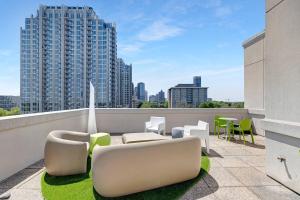 a balcony with chairs and tables on a building at The Eighth Luxury Penthouse in Fourth Ward in Charlotte