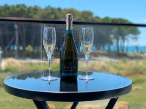 a bottle of wine and two glasses on a table at Vila Élysée in Spille